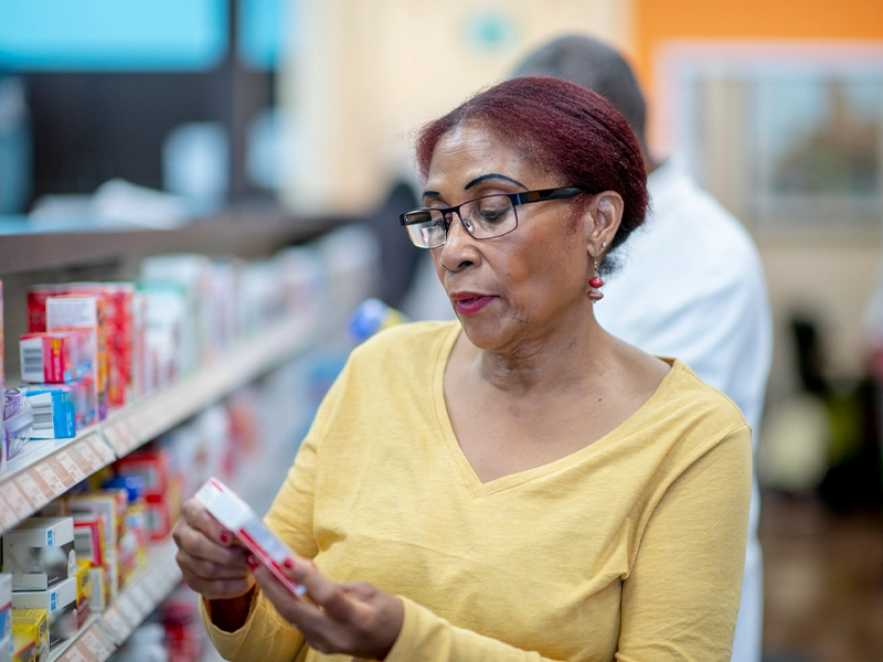 woman selecting a medicine at the pharmacy