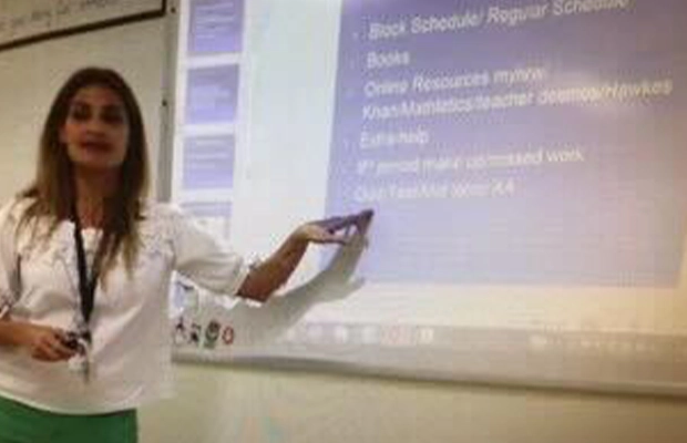 Photograph of a woman giving a digital slideshow presentation
