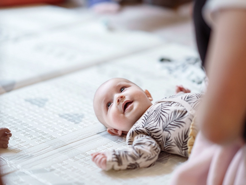 baby lying on a bed
