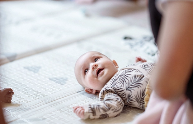 baby lying on a bed