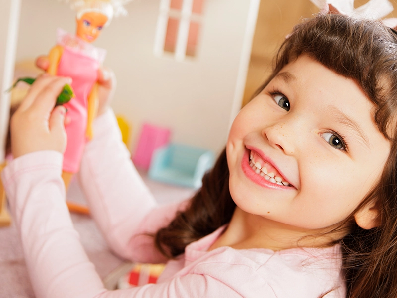 Girl playing with a Barbie