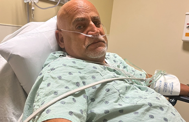 hospitalized man in blue gown