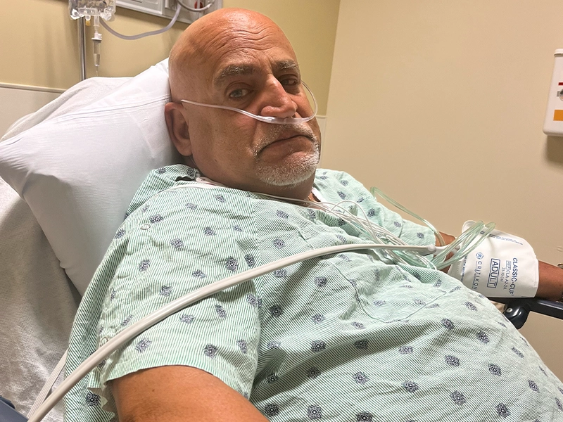 hospitalized man in blue gown