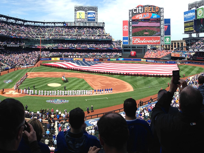 Baseball stadium displaying the United States flag in the middle