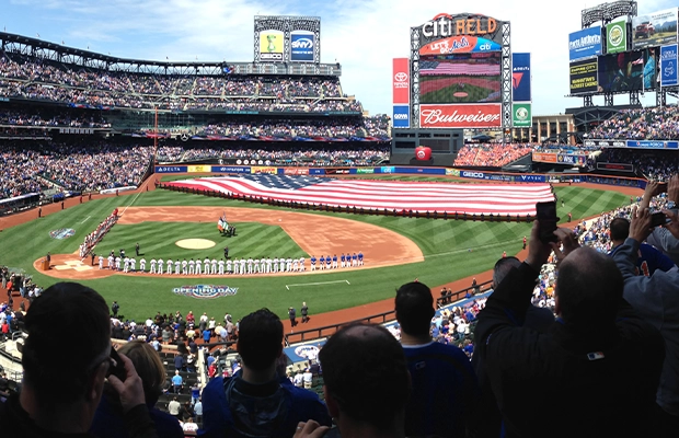 Baseball stadium displaying the United States flag in the middle