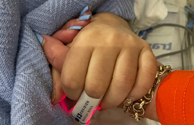 Close-up of hands clasping each other