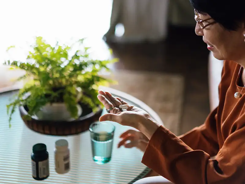 adult woman taking her medication
