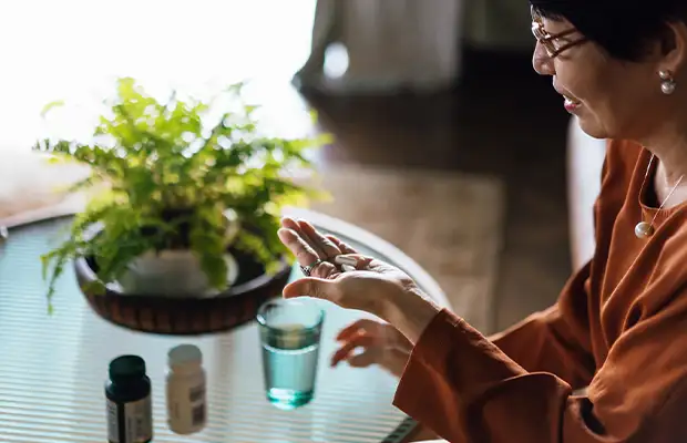 adult woman taking her medication