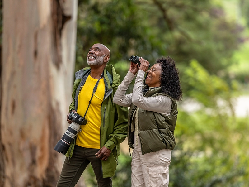 A couple taking photos in the park