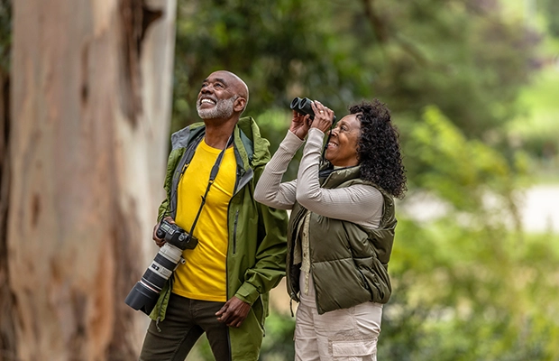 A couple taking photos in the park