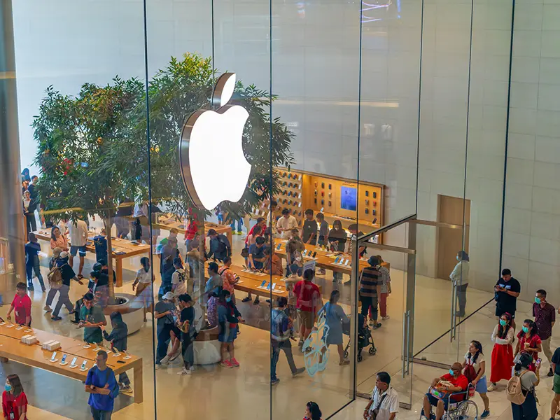 A view of an Apple store with people outside and inside