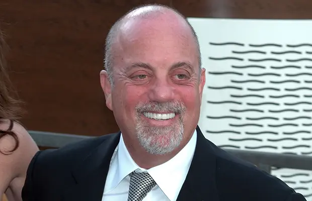A closeup of a man, he has on a suit and tie