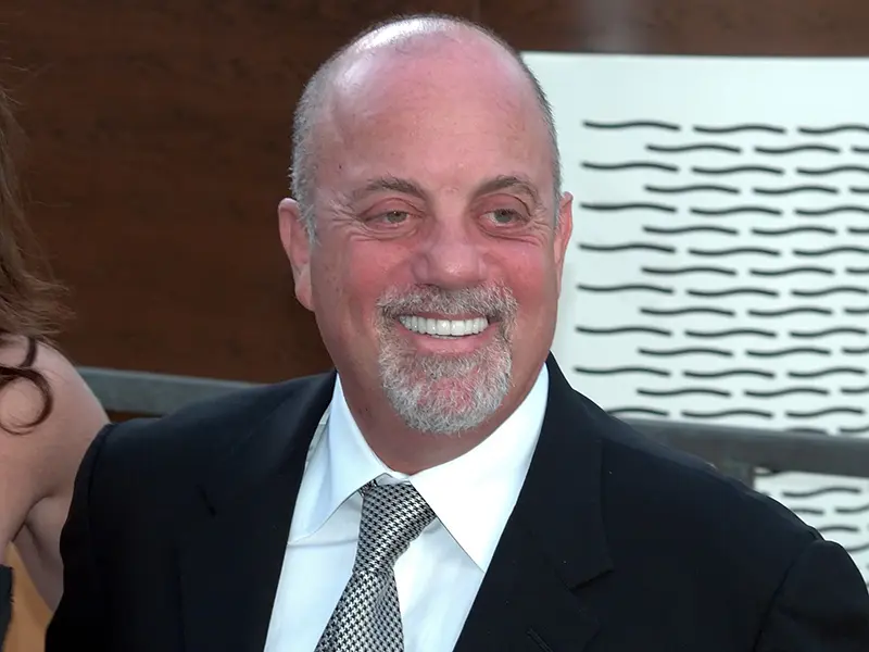 A closeup of a man, he has on a suit and tie