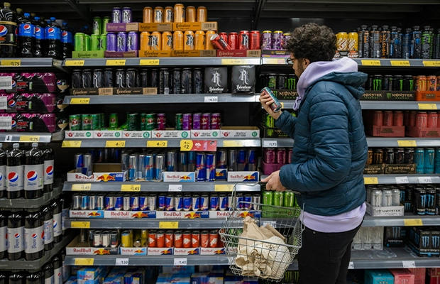 Person choosing a drink from the refrigerator in a supermarket