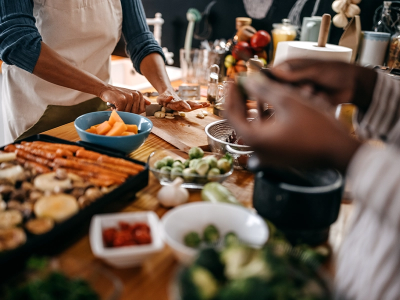Close-up of a person handling a table full of food