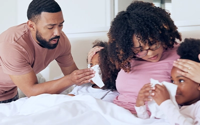 a couple checking their children's fever