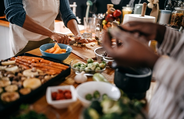 Close-up of a person handling a table full of food