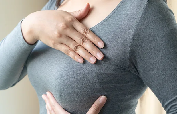 woman performing breast self-examination
