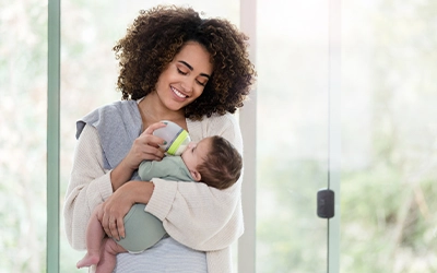woman feeding her baby with a bottle