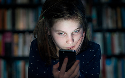 closeup of sad girl watching the cell phone