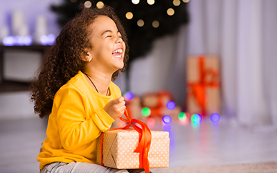 girl smiling with a gift in her hand