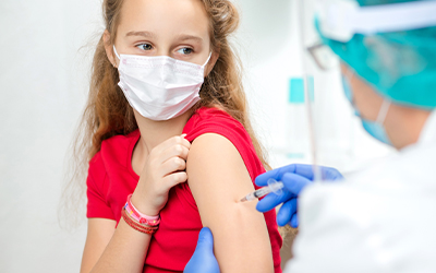 Girl being vaccinated