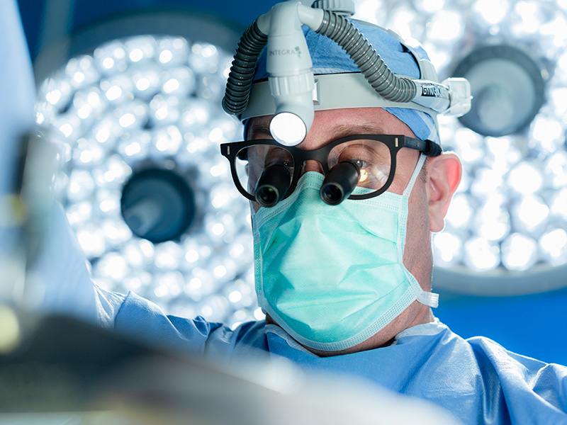 Closeup of a cardiac surgeon as he performs a heart surgery