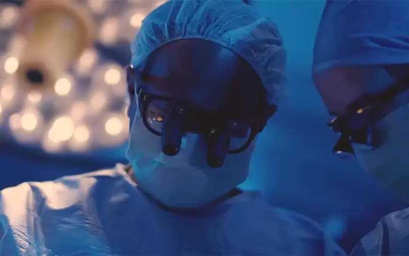A closeup of two surgeons performing surgery