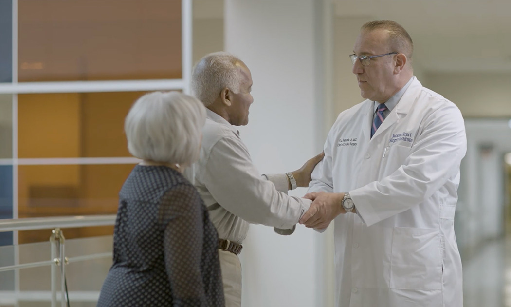 Dr. Segurola greeting a patient and his wife