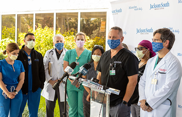 Medical professionals at an event speaking to the media