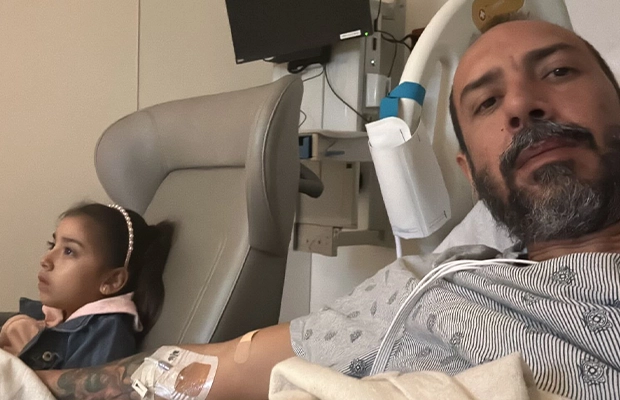 hospitalized man sitting next to his daughter