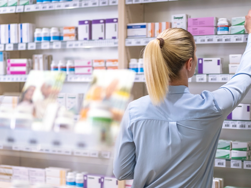 woman selecting a product in a pharmacy