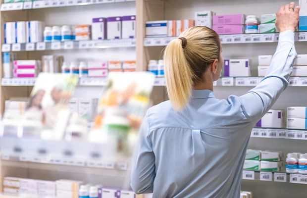 woman selecting a product in a pharmacy