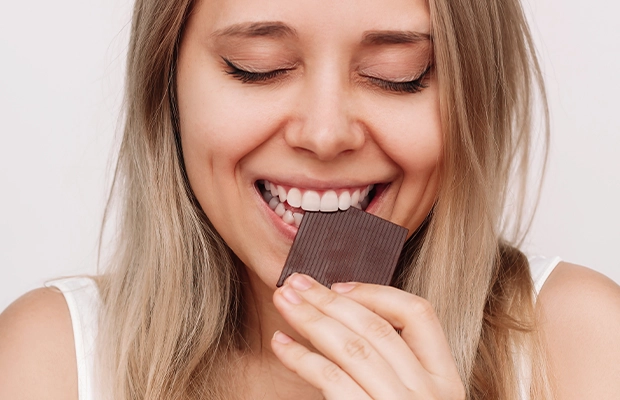 close up of women eating chocolate