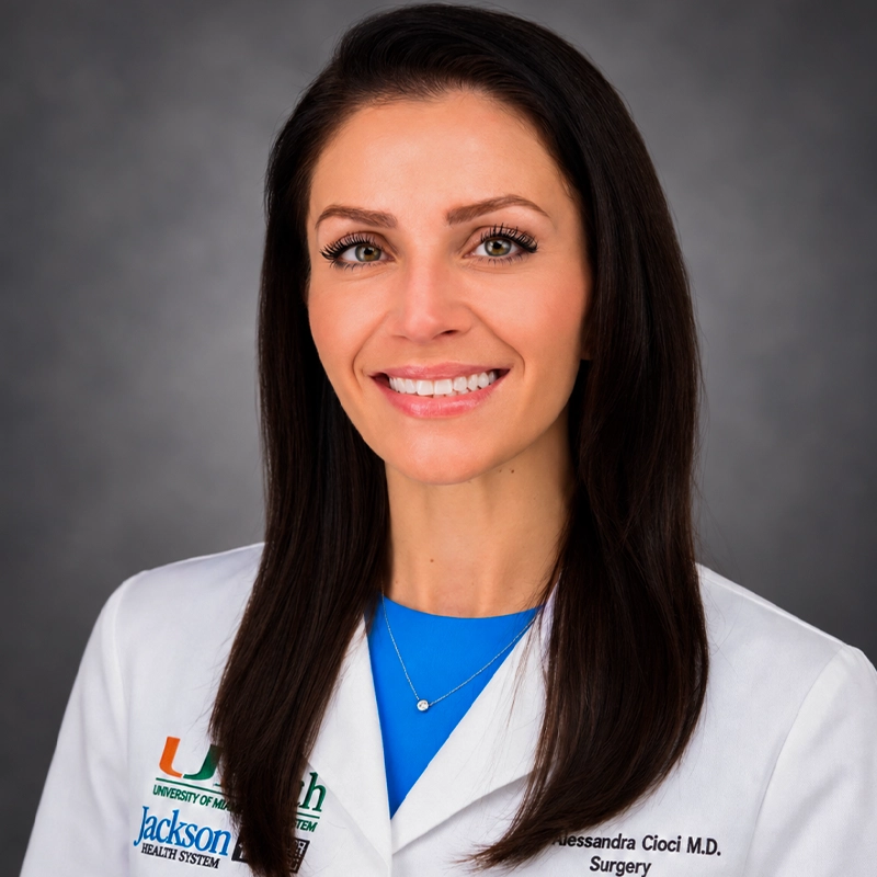 Close-up of a woman wearing a doctor's coat.