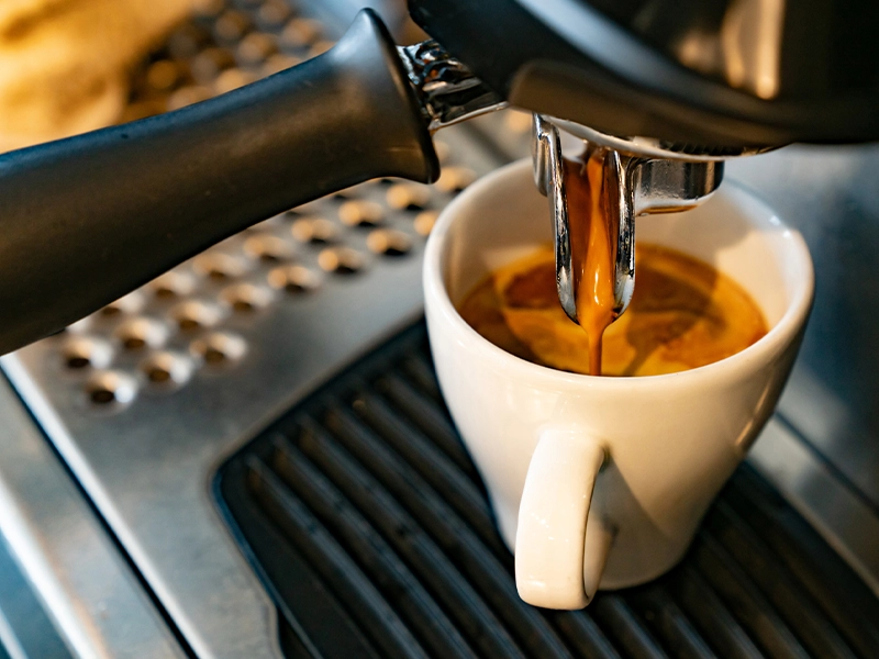 Close-up of coffee being poured from a coffee pot.
