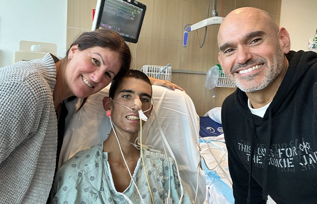 Young hospitalized woman smiling with man and woman