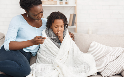 Mom taking her son's temperature