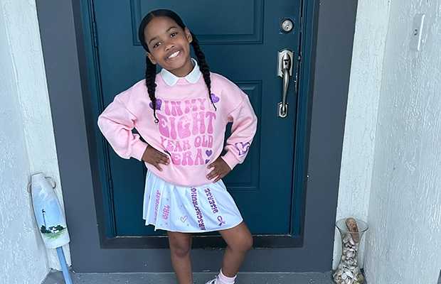 a girl posing and smiling at the camera