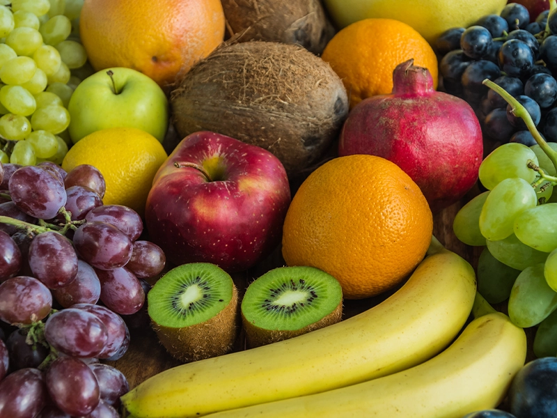 An image showing apples, bananas, papayas, grapes, oranges, coconuts, and kiwis.
