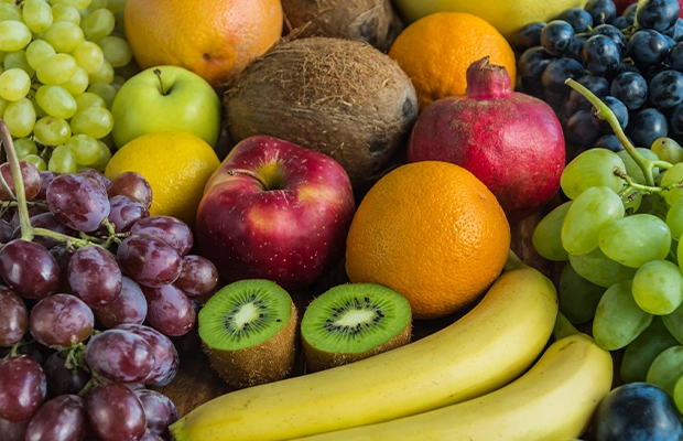 An image showing apples, bananas, papayas, grapes, oranges, coconuts, and kiwis.