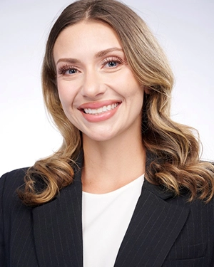 Close-up of a blonde woman smiling at the camera.