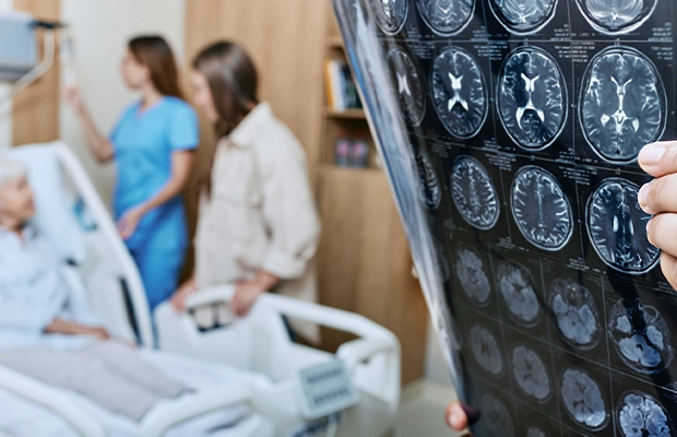 Photo of an x-ray with a nurse and patient behind it