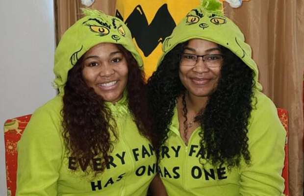 Two women wearing Grinch pijamas