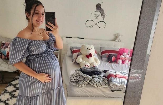 pregnant woman taking photo in front of the mirror