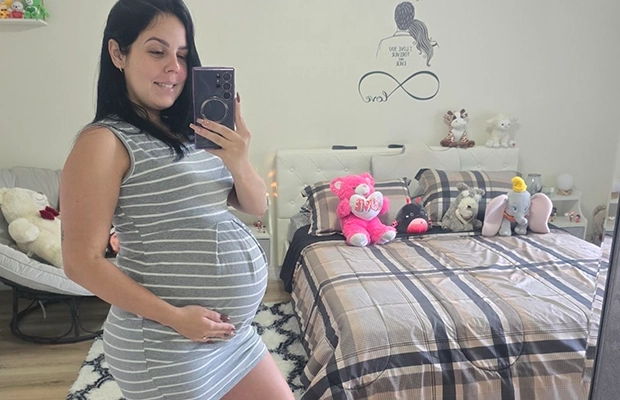 pregnant woman taking photo in front of the mirror