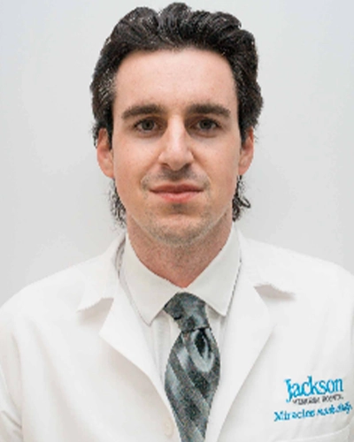 Professional headshot of Donald-C, a man smiling, against a white studio background