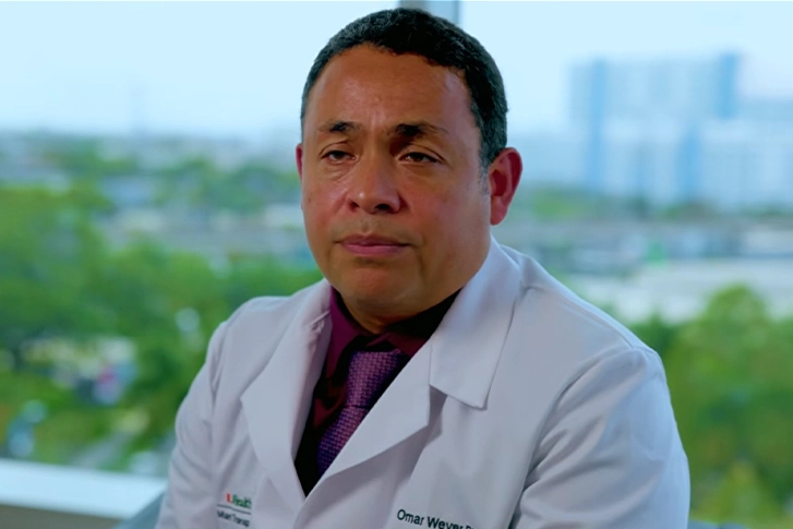 Close-up of a man wearing a doctor's coat.