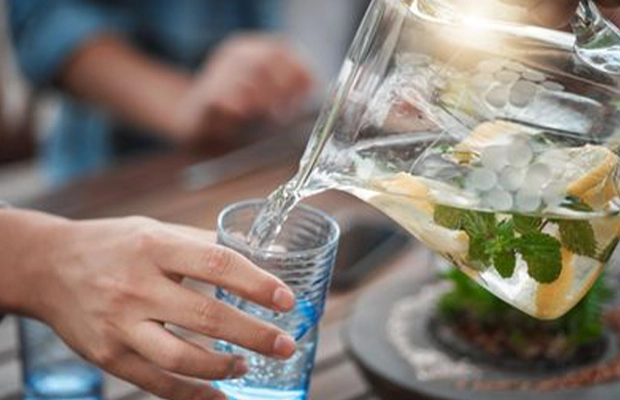 Close-up of a hand serving a drink