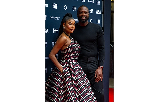 elegant dressed couple posing at gala event